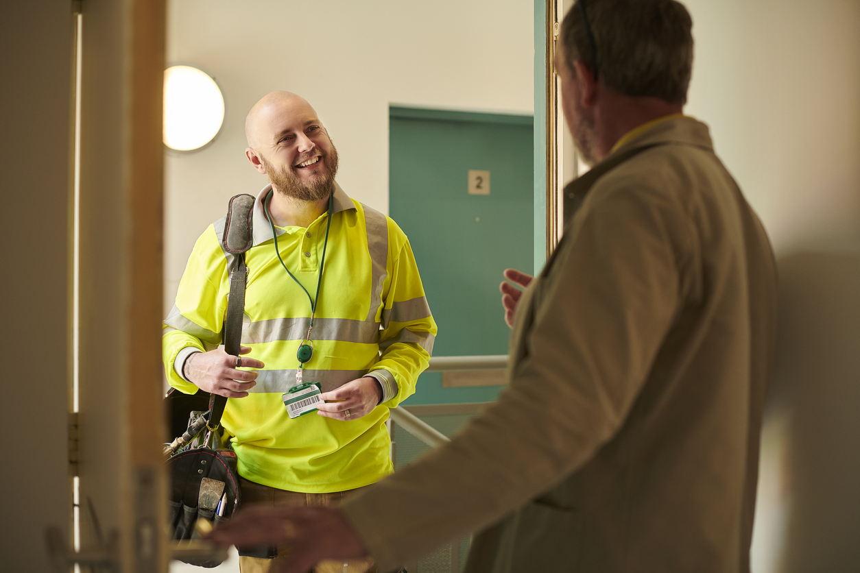 friendly contractor in a social housing apartment block arriving from a booked appointment through the social housing omni-channel contact centre.